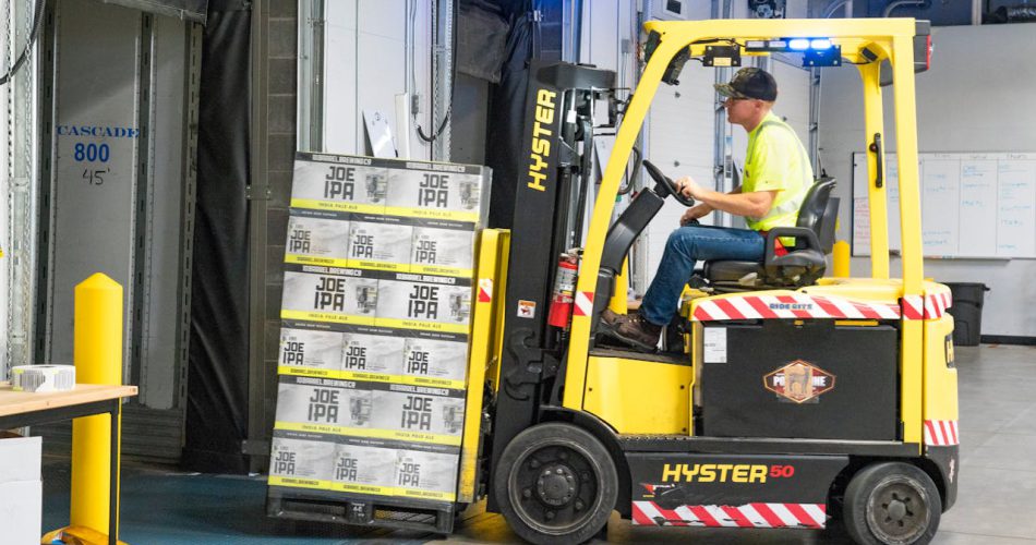 man-riding-a-yellow-forklift-lifting-boxes