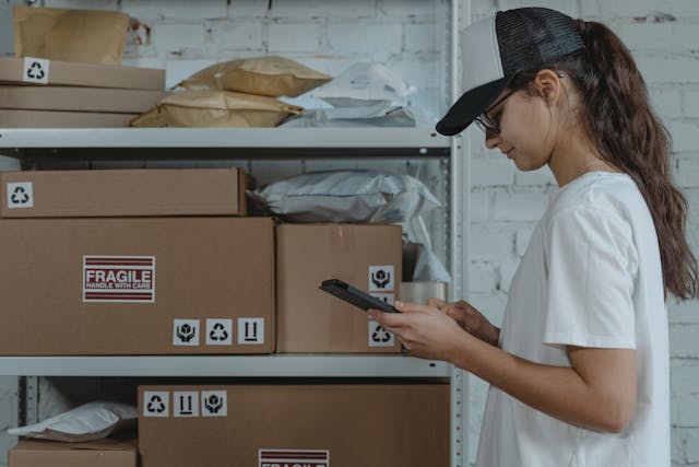 woman-in-white-shirt-holding-black-smartphone